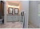 Modern bathroom with double vanity, granite countertops, and tiled shower at 1494 Addison Pl, Decatur, GA 30033