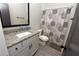 Bathroom featuring a granite vanity, tile flooring, and shower with a modern patterned shower curtain at 1494 Addison Pl, Decatur, GA 30033