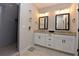 Modern bathroom featuring dual vanity with granite countertops, tiled shower, and decorative wall planters at 1494 Addison Pl, Decatur, GA 30033