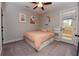 Bright bedroom featuring a comfortable bed, ceiling fan, and access to the outdoors, creating a serene retreat at 1494 Addison Pl, Decatur, GA 30033