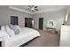 Spacious bedroom with tray ceilings, carpeted floors, and a vanity table at 1494 Addison Pl, Decatur, GA 30033
