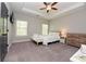 Bright bedroom features a tray ceiling, bench, and large windows for natural light at 1494 Addison Pl, Decatur, GA 30033