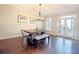 Bright dining room features hardwood floors, a modern chandelier and double doors to the outside at 1494 Addison Pl, Decatur, GA 30033