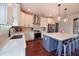Modern kitchen with white cabinets, gray backsplash, stainless appliances and kitchen island seating at 1494 Addison Pl, Decatur, GA 30033