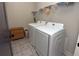 Functional laundry room with modern washer and dryer set and overhead shelving at 1494 Addison Pl, Decatur, GA 30033