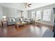 Inviting living room with hardwood flooring, sectional couch, and large windows offering plenty of light at 1494 Addison Pl, Decatur, GA 30033