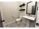 Charming powder room with patterned floors, a pedestal sink, and stylish decor at 1494 Addison Pl, Decatur, GA 30033