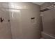 Close-up of modern shower with gray subway tile, rainfall showerhead, and built-in niche at 1494 Addison Pl, Decatur, GA 30033