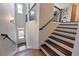 Elegant staircase featuring wooden treads, black iron railings, and a view to the front door at 1494 Addison Pl, Decatur, GA 30033
