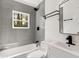 Modern bathroom features gray subway tiles, white vanity, and sleek black fixtures at 2007 Glenwood Se Ave, Atlanta, GA 30316