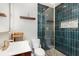 Stylish bathroom with teal tiling, glass shower enclosure, and modern fixtures at 2007 Glenwood Se Ave, Atlanta, GA 30316
