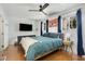 Bright bedroom featuring hardwood floors, a ceiling fan, and a cozy bed with plush bedding at 2007 Glenwood Se Ave, Atlanta, GA 30316