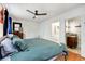 Well-lit bedroom featuring a bathroom, a ceiling fan, and hardwood floors at 2007 Glenwood Se Ave, Atlanta, GA 30316