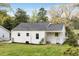 Rear exterior view of a cozy white cottage-style home with well-kept lawn at 2007 Glenwood Se Ave, Atlanta, GA 30316