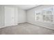 Comfortable bedroom with a large window and neutral carpeting at 210 Millpond Pkwy, Villa Rica, GA 30180