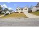 View of house, driveway, and yard, in suburban location at 210 Millpond Pkwy, Villa Rica, GA 30180