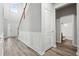 Bright entryway featuring hardwood floors, staircase, and view of a bathroom at 210 Millpond Pkwy, Villa Rica, GA 30180