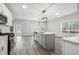 Modern kitchen with island, stainless appliances, and gray cabinetry at 210 Millpond Pkwy, Villa Rica, GA 30180