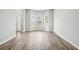 Open living room with a large bay window and modern flooring at 210 Millpond Pkwy, Villa Rica, GA 30180