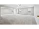Expansive main bedroom boasts plush carpeting, a ceiling fan, and abundant natural light from multiple windows at 210 Millpond Pkwy, Villa Rica, GA 30180
