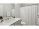 Bright bathroom featuring a modern sink vanity with a stylish faucet and a shower with a clean, white curtain at 2420 Lakeshore Se Ln, Atlanta, GA 30316