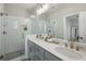 Elegant bathroom with a double sink vanity, a large mirror, and a glass-enclosed shower at 2420 Lakeshore Se Ln, Atlanta, GA 30316