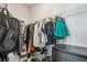 Walk-in closet featuring wire shelving and rods filled with clothes, shoes, and accessories, with a dark dresser at 2420 Lakeshore Se Ln, Atlanta, GA 30316