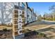 The Parc community sign showcasing modern townhomes with white brick exteriors and well-manicured lawns at 2420 Lakeshore Se Ln, Atlanta, GA 30316