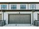 Attached garage with a gray door and visible house number, complemented by the home's neutral exterior at 2420 Lakeshore Se Ln, Atlanta, GA 30316