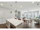 Open floor plan with a modern kitchen island flowing into the living room and dining area at 2420 Lakeshore Se Ln, Atlanta, GA 30316