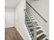 Modern stairway with black metal railing and hardwood steps leading to the upper level at 2420 Lakeshore Se Ln, Atlanta, GA 30316