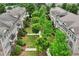Aerial perspective of townhomes arranged around a central courtyard with mature trees and green space at 4934 Wyeth Way, Johns Creek, GA 30022