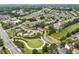 Beautiful aerial view of a vibrant community with lush green spaces, walking trails, and a playground at 4934 Wyeth Way, Johns Creek, GA 30022