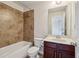 Bathroom featuring a tub-shower combination with tiled wall and a single sink vanity at 4934 Wyeth Way, Johns Creek, GA 30022