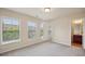 Sunny bedroom with three windows and a door leading to the bathroom at 4934 Wyeth Way, Johns Creek, GA 30022