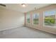 Comfortable bedroom with three windows, carpeting and neutral colors at 4934 Wyeth Way, Johns Creek, GA 30022