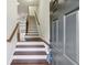 Entryway of home featuring wooden stairs, railing, and door with dark hardware at 4934 Wyeth Way, Johns Creek, GA 30022