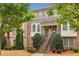 Exterior of a brick townhouse with stairs leading to the entrance and landscaping in the front at 4934 Wyeth Way, Johns Creek, GA 30022