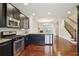 Updated kitchen featuring modern appliances, granite countertops, and open floor plan at 4934 Wyeth Way, Johns Creek, GA 30022