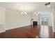 Bright living room featuring a fireplace, hardwood floors, and sliding door to the backyard at 4934 Wyeth Way, Johns Creek, GA 30022