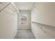 Spacious walk-in closet with metal storage racks and a window for natural light at 4934 Wyeth Way, Johns Creek, GA 30022