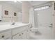 Bathroom with white vanity, framed mirror, a toilet and combined tub and shower at 5578 Hedge Brooke Dr, Acworth, GA 30101