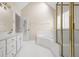 Bathroom with soaking tub, shower with glass enclosure, white tiled floors, and natural light at 5578 Hedge Brooke Dr, Acworth, GA 30101