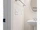 Close-up of a bathroom featuring a pedestal sink, an oval mirror, and a towel rack at 5578 Hedge Brooke Dr, Acworth, GA 30101