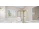 Bathroom with large soaking tub, step-in shower, gold trim, and natural light at 5578 Hedge Brooke Dr, Acworth, GA 30101