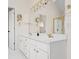 Bright bathroom featuring a double vanity, tub, and separate shower with gold trim at 5578 Hedge Brooke Dr, Acworth, GA 30101