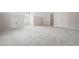 Spacious bedroom featuring a large open layout with neutral carpet and many access doors at 5578 Hedge Brooke Dr, Acworth, GA 30101