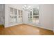 Bright dining area with wood floors, large windows with shutters, and a chandelier at 5578 Hedge Brooke Dr, Acworth, GA 30101