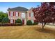 Charming brick home with red shutters and a well-manicured front yard at 5578 Hedge Brooke Dr, Acworth, GA 30101