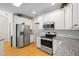 Well-lit kitchen boasts stainless steel refrigerator and oven, plus granite countertops at 5578 Hedge Brooke Dr, Acworth, GA 30101
